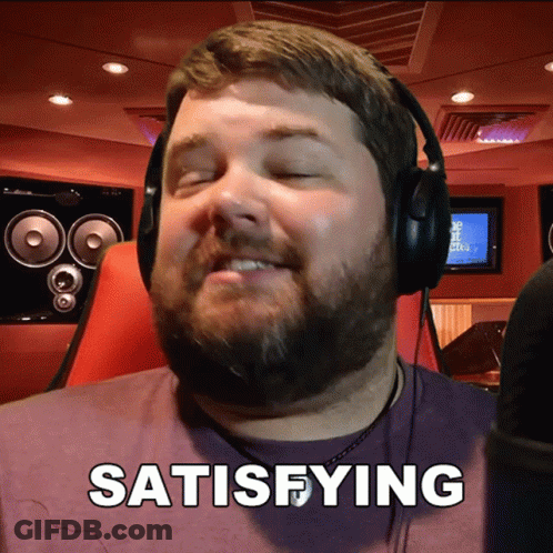 A Man Wearing Headphones Says Satisfying In Front Of A Microphone GIF