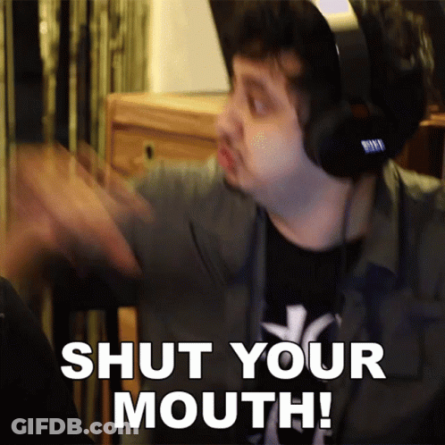 A Man Wearing Headphones Says " Shut Your Mouth " In White Letters GIF