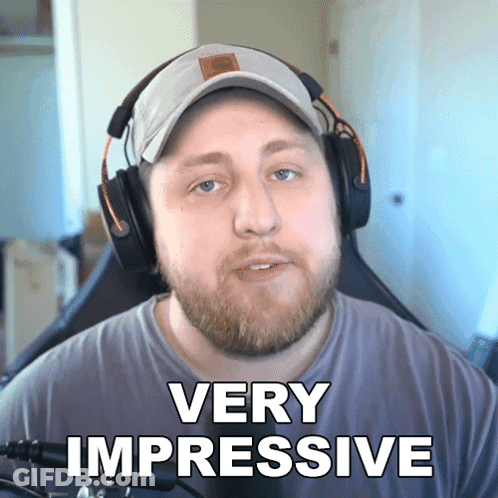 A Man Wearing Headphones Says Very Impressive In Front Of A Microphone GIF