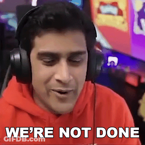 A Man Wearing Headphones Says " We 'Re Not Done " In Front Of A Computer Screen GIF