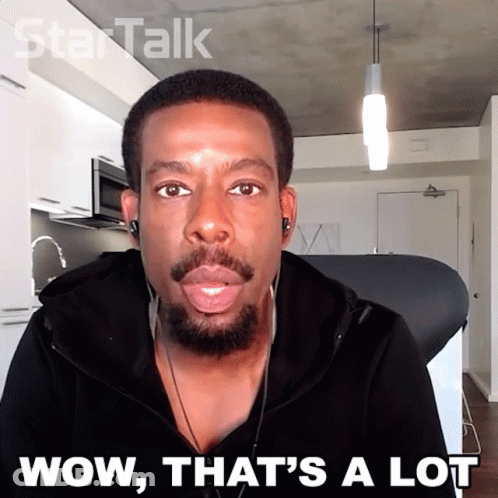 A Man Wearing Headphones Says Wow That 'S A Lot In Front Of A Kitchen GIF