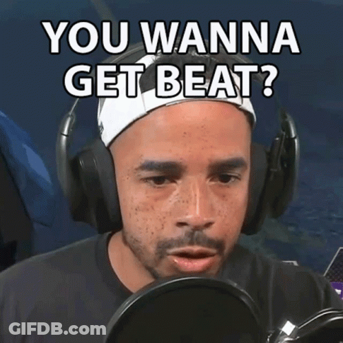 A Man Wearing Headphones Says " You Wanna Get Beat " In Front Of A Microphone GIF