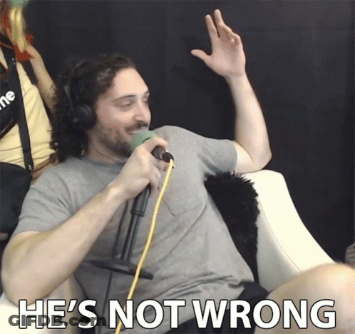 A Man Wearing Headphones Singing Into A Microphone With The Words He 'S Not Wrong Below Him GIF
