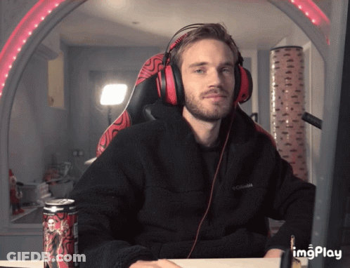A Man Wearing Headphones Sits At A Desk With A Can Of Monster Energy Drink In Front Of Him GIF