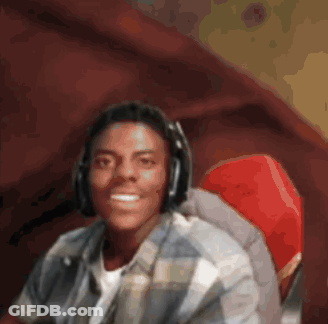 A Man Wearing Headphones Sits In A Red Chair GIF