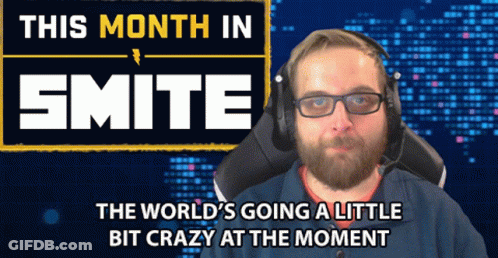 A Man Wearing Headphones Sits In Front Of A Sign That Says ' This Month In Smite ' GIF