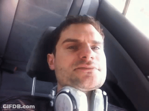 A Man Wearing Headphones Sitting In A Car GIF