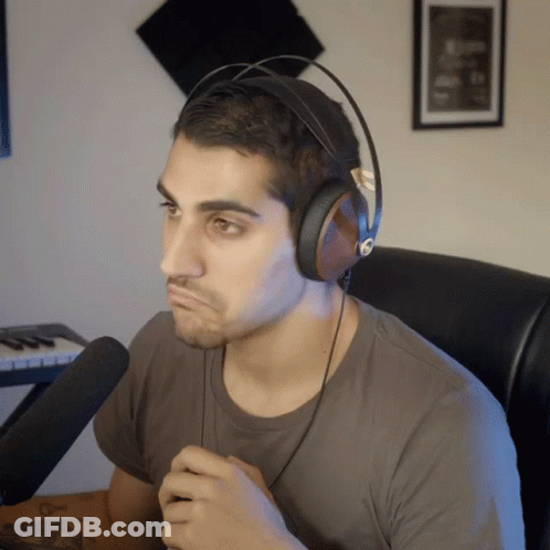 A Man Wearing Headphones Sitting In Front Of A Keyboard GIF