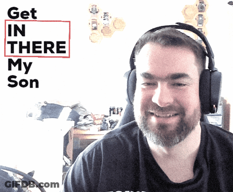 A Man Wearing Headphones Smiles In Front Of A Sign That Says " Get In There My Son " GIF
