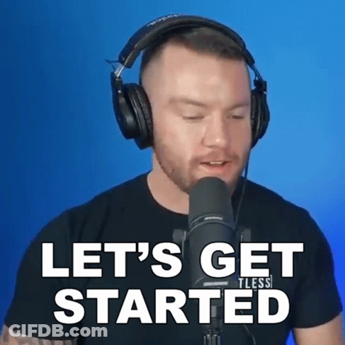 A Man Wearing Headphones Stands In Front Of A Microphone And Says " Let 'S Get Started " GIF