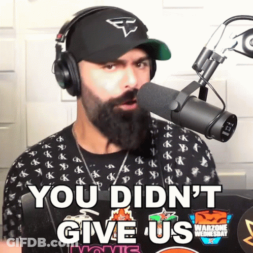 A Man Wearing Headphones Stands In Front Of A Microphone And Says You Didn 'T Give Us GIF