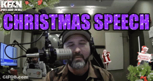 A Man Wearing Headphones Stands In Front Of A Microphone With The Words " Christmas Speech " Above Him GIF