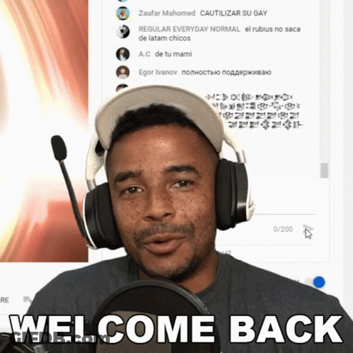 A Man Wearing Headphones Stands In Front Of A Microphone With The Words Welcome Back On The Bottom GIF