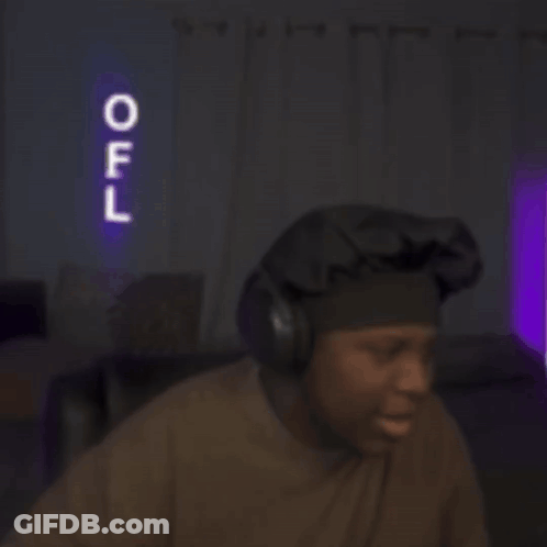 A Man Wearing Headphones Stands In Front Of A Neon Sign That Says Off GIF