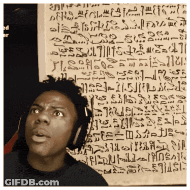 A Man Wearing Headphones Stands In Front Of A Wall With Ancient Writing GIF