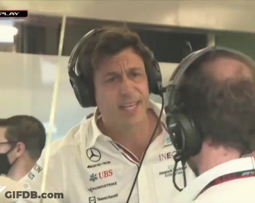A Man Wearing Headphones Talks To Another Man Who Is Wearing A Shirt That Says Ubs GIF