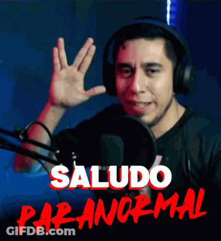 A Man Wearing Headphones Waves His Hand In Front Of A Microphone With The Words Saludo Paranormal Written In Red GIF