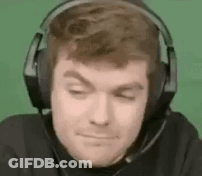 A Man Wearing Headphones With A Microphone On His Head Is Making A Funny Face . GIF