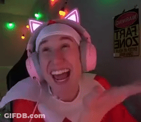 A Man Wearing Headphones With Glowing Cat Ears Is Smiling In Front Of A Sign That Says " Warning " GIF