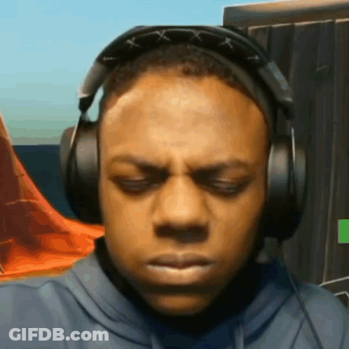 A Man Wearing Headphones With His Eyes Closed Is Making A Funny Face . GIF