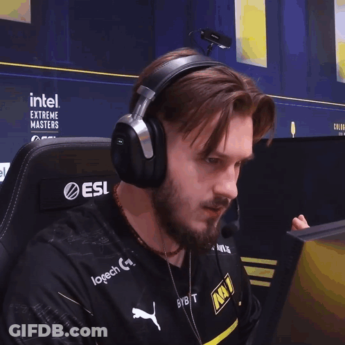 A Man Wearing Headphones With Intel Extreme Masters Written On The Back GIF