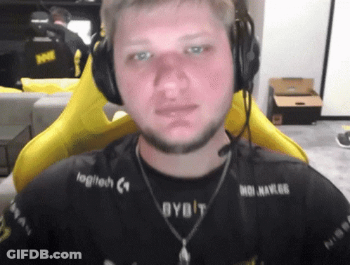 A Man Wearing Headphones With Logitech Written On His Shirt GIF