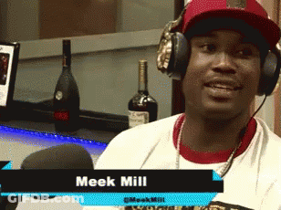 A Man Wearing Headphones With The Name Meek Mill On The Bottom Right GIF