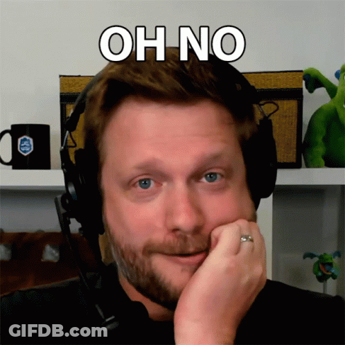 A Man Wearing Headphones With The Words Oh No Written Above His Head GIF