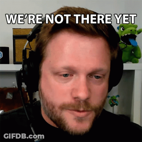 A Man Wearing Headphones With The Words We 'Re Not There Yet Above Him GIF