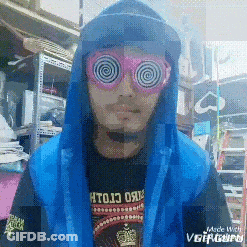 A Man Wearing Hypnotic Glasses And A Blue Hooded Jacket GIF