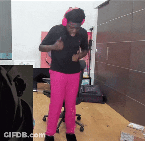 A Man Wearing Pink Pants And Headphones Is Standing In A Room GIF