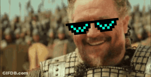A Man Wearing Pixelated Sunglasses With The Letter W On Them Smiles GIF
