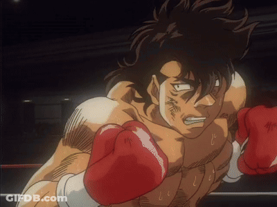 A Man Wearing Red Boxing Gloves In A Boxing Ring GIF