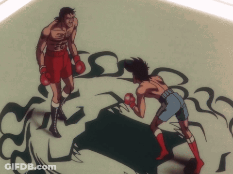 A Man Wearing Red Boxing Gloves Is Being Punched By Another Man GIF