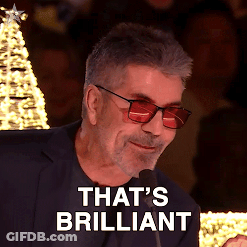 A Man Wearing Red Glasses And A Suit Says That 'S Brilliant GIF