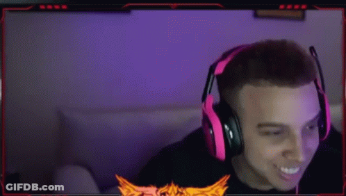 A Man Wearing Red Headphones Is Sitting In Front Of A Computer Monitor . GIF