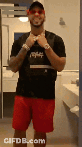 A Man Wearing Red Shorts And A Black Shirt With A Letter A On It GIF