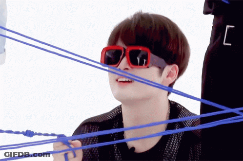 A Man Wearing Red Sunglasses Is Surrounded By Blue Rope GIF