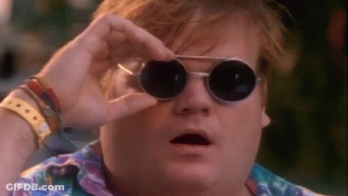 A Man Wearing Round Sunglasses Is Looking Through His Glasses . GIF