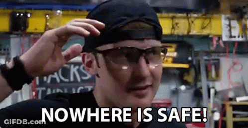 A Man Wearing Safety Glasses And A Hat Is Saying `` Nowhere Is Safe ! '' GIF