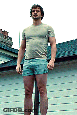 A Man Wearing Shorts And A T-Shirt Is Standing On A Pole GIF
