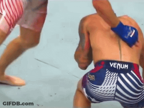 A Man Wearing Shorts That Say Venum On The Back GIF