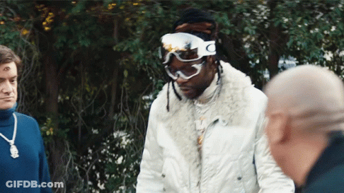 A Man Wearing Ski Goggles With The Letter C On The Side GIF