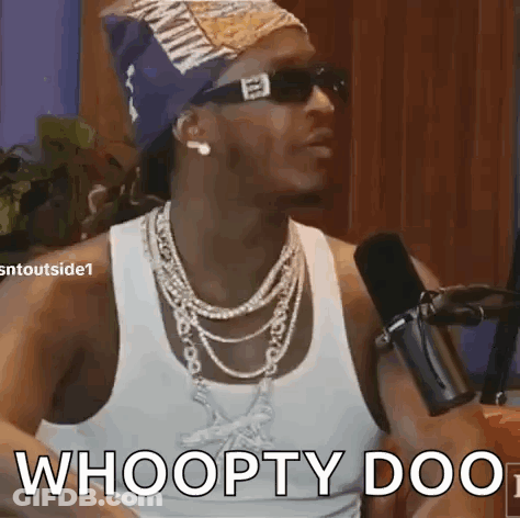 A Man Wearing Sunglasses And A Bandana Is Talking Into A Microphone . GIF