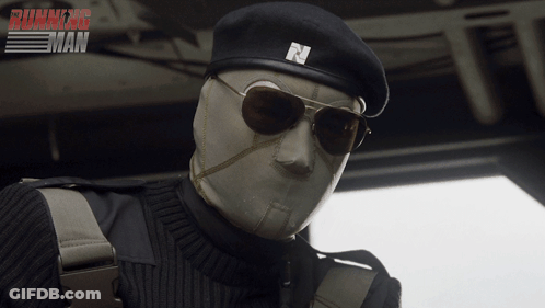 A Man Wearing Sunglasses And A Beret With The Letter N On It Is In Front Of A Running Man Poster GIF