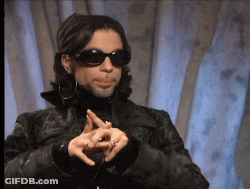 A Man Wearing Sunglasses And A Black Jacket Is Making A Peace Sign With His Hands GIF