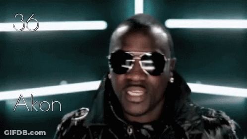 A Man Wearing Sunglasses And A Black Jacket With The Name Akon Written On The Bottom GIF