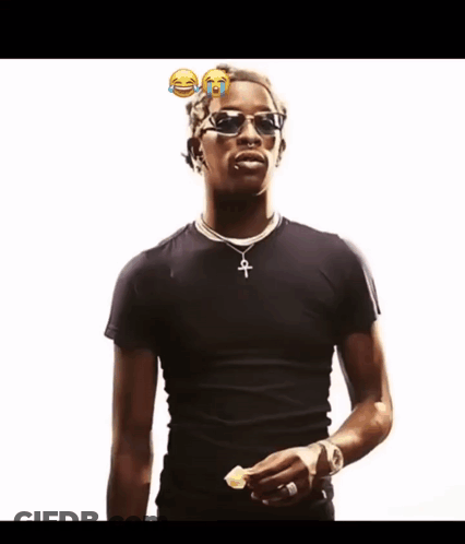 A Man Wearing Sunglasses And A Black Shirt Has A Cross Necklace GIF