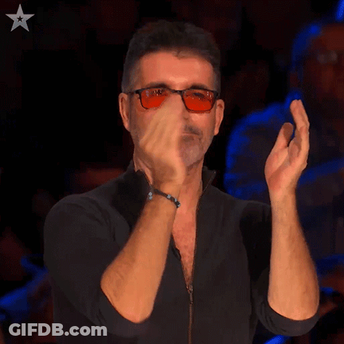 A Man Wearing Sunglasses And A Black Shirt Is Clapping His Hands GIF