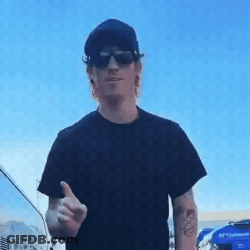 A Man Wearing Sunglasses And A Black Shirt Is Giving A Thumbs Up GIF